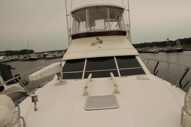 Slide: The Image of 1996 Silverton 41 Convertible yacht docked in a marina, showcasing its sleek design. - 38