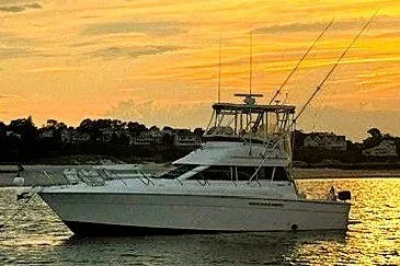 Slide: The Image of 1996 Silverton 41 Convertible yacht at sunset on calm waters. - 1