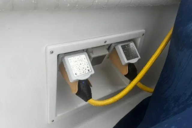 Slide: The Image of Power outlets with yellow cables on a 1996 Silverton 41 Convertible boat. - 23