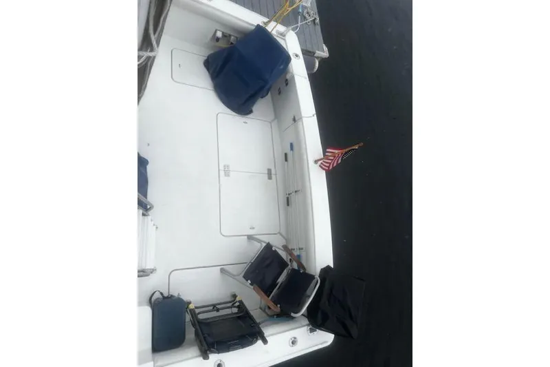 Slide: The Image of 1996 Silverton 41 Convertible boat deck with chairs and American flag. - 14