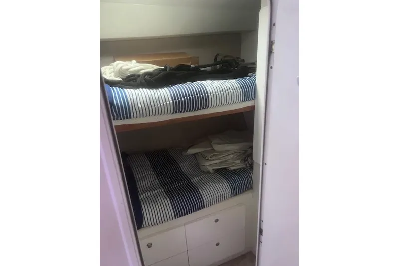 Slide: The Image of Bunk beds with striped bedding inside a 1996 Silverton 41 Convertible yacht cabin. - 20