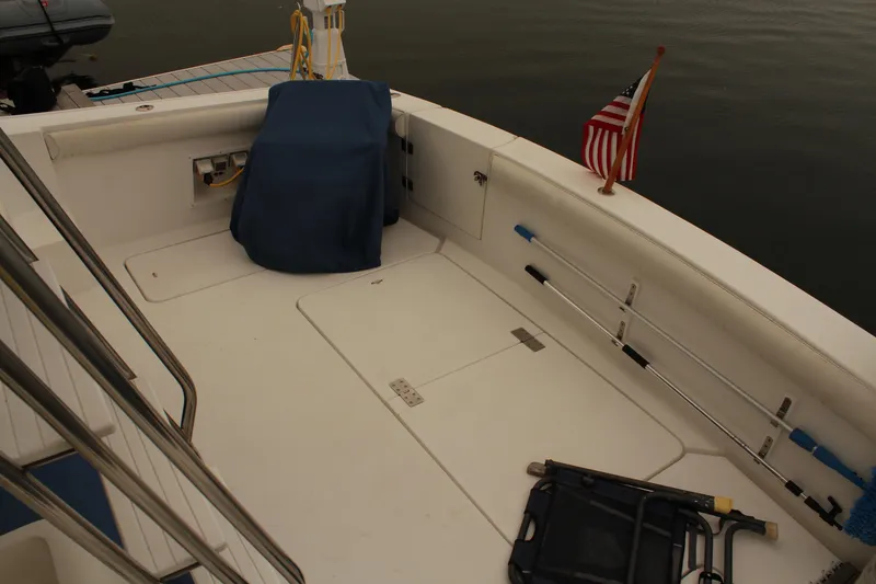 Slide: The Image of 1996 Silverton 41 Convertible boat deck with American flag and covered equipment. - 34