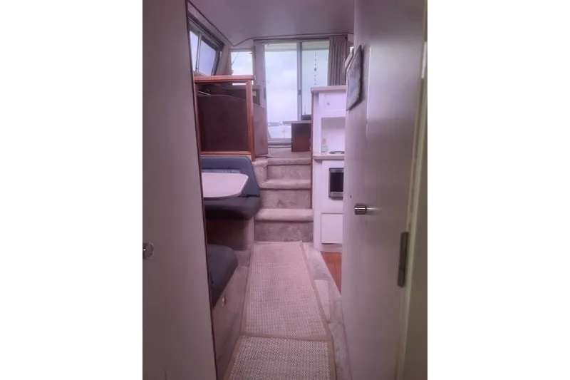 Slide: The Image of Interior view of a 1996 Silverton 41 Convertible yacht, featuring a cozy cabin layout. - 17