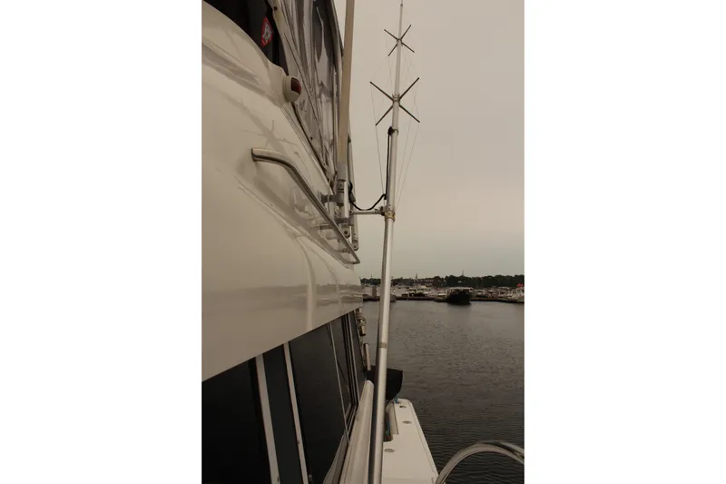 Slide: The Image of 1996 Silverton 41 Convertible yacht docked, showcasing side view and antenna. - 24