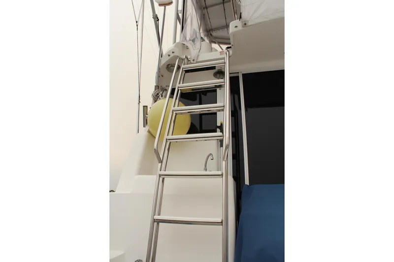 Slide: The Image of Stainless steel ladder on 1996 Silverton 41 Convertible yacht, with yellow buoy and blue cover. - 33