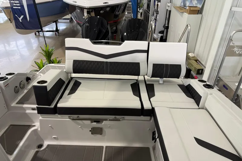Slide: The Image of Luxury seating on a 2027 Monterey Elite 27 OB boat, featuring sleek black and white upholstery. - 13