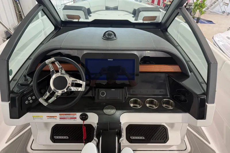 Slide: The Image of Cockpit of 2027 Monterey Elite 27 OB boat with modern steering and controls. - 10