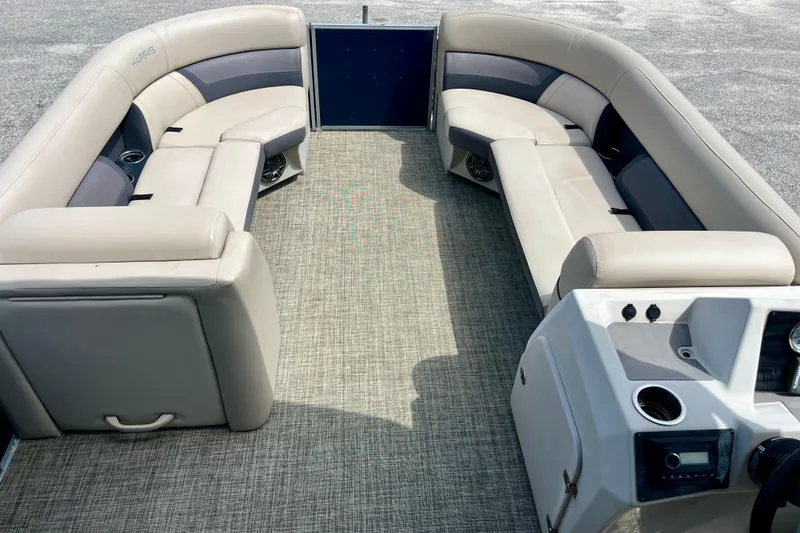 Slide: The Image of 2023 Harris Cruiser 230 pontoon boat interior with spacious seating and modern dashboard. - 8