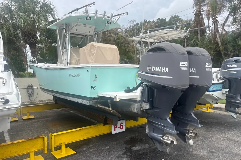 Slide: The Image of 2008 Regulator 26 Forward Seating boat with twin Yamaha 250 engines on a trailer. - 2