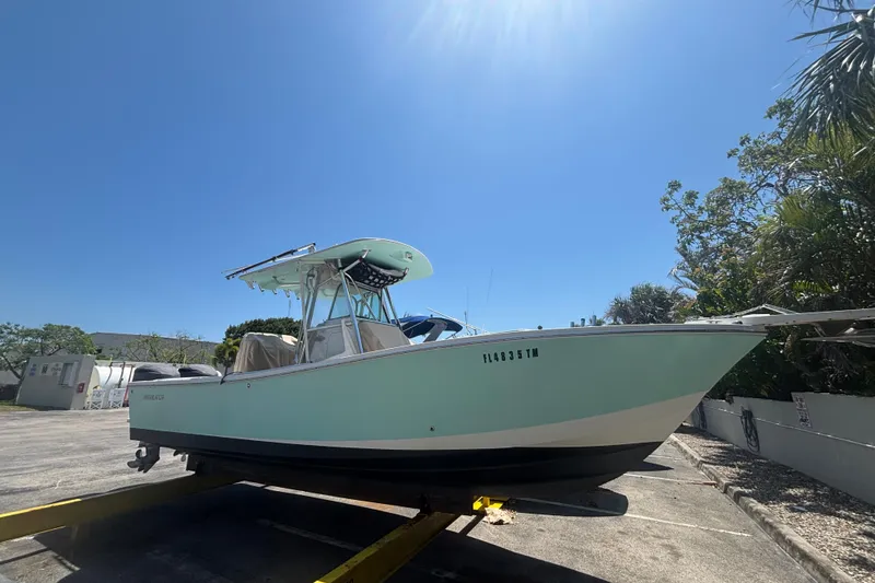 The Image of 2008 Regulator 26 Forward Seating boat on trailer under clear blue sky. - 0