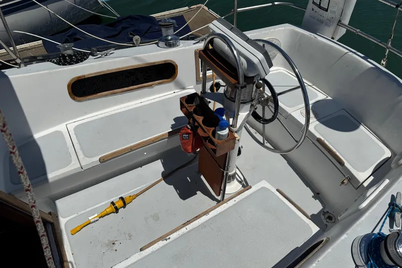 Slide: The Image of Cockpit of a 1976 Islander 36 sailboat with steering wheel and equipment. - 7