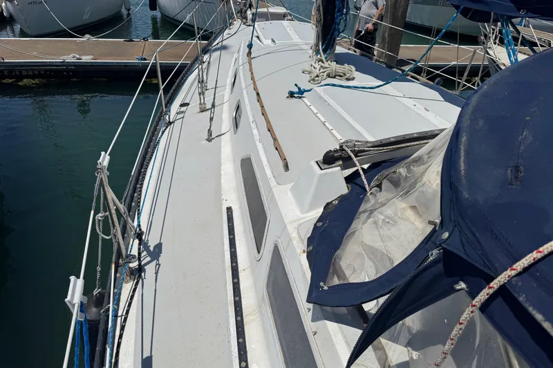 Slide: The Image of 1976 Islander 36 sailboat docked, featuring deck and rigging details. - 6