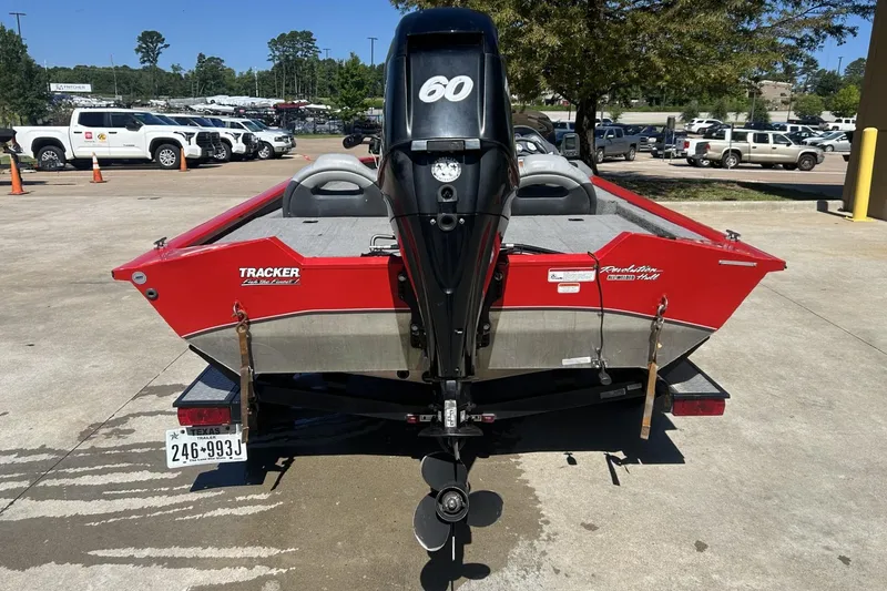 Slide: The Image of 2008 Tracker Pro Team 175 TXW boat with a 60 HP engine, parked outdoors. - 3