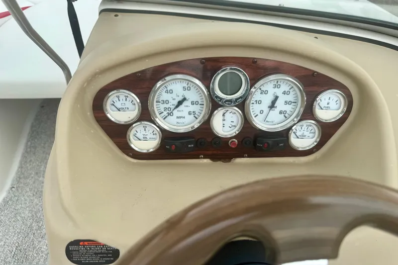 Slide: The Image of Dashboard of a 2008 Glastron GT 225 boat with gauges and controls. - 25