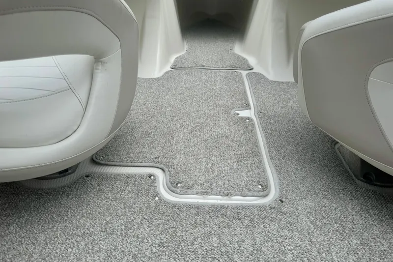 Slide: The Image of 2008 Glastron GT 225 boat interior with gray carpet and white seats. - 58
