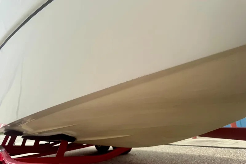 Slide: The Image of 2008 Glastron GT 225 boat hull on red trailer, close-up view. - 67
