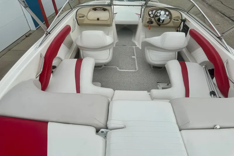 Slide: The Image of 2008 Glastron GT 225 boat interior with red and white seating, steering console, and spacious layout. - 20