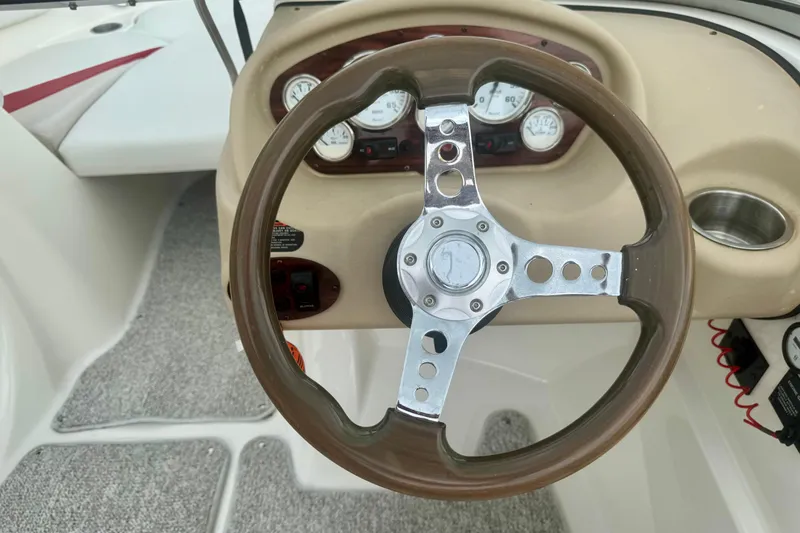 Slide: The Image of Steering wheel and dashboard of a 2008 Glastron GT 225 boat. - 24