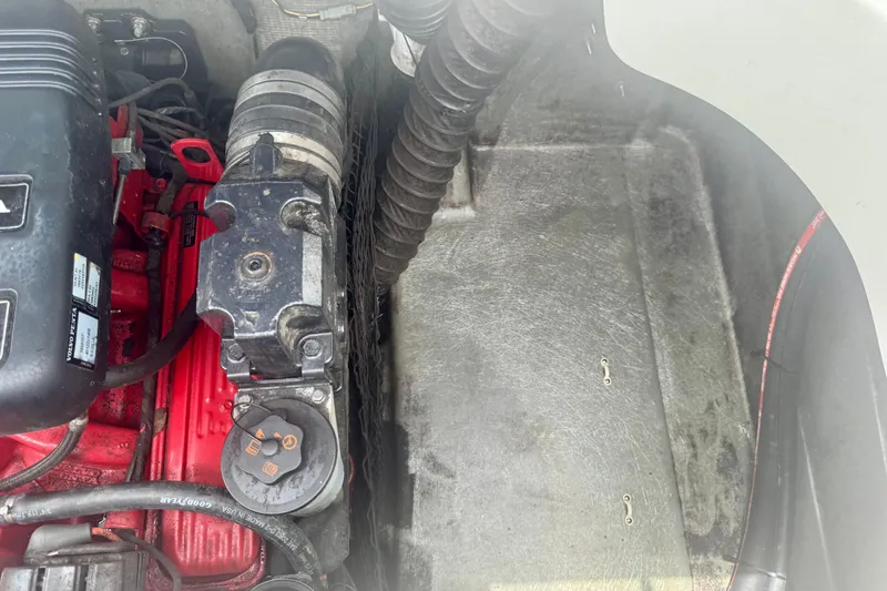 Slide: The Image of Engine compartment of a 2008 Glastron GT 225 boat, showing mechanical components and wiring. - 52