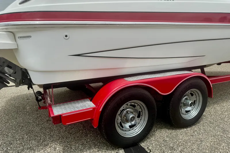 Slide: The Image of 2008 Glastron GT 225 boat on red dual-axle trailer, side view. - 64