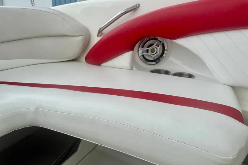 Slide: The Image of 2008 Glastron GT 225 boat interior with white and red seating, speaker, and cup holders. - 30