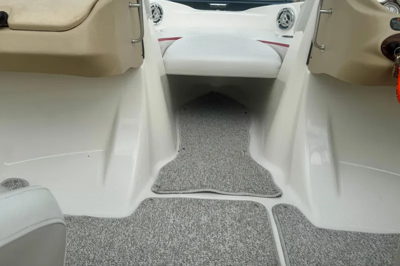 Slide: The Image of Interior view of a 2008 Glastron GT 225 boat with carpeted flooring. - 39