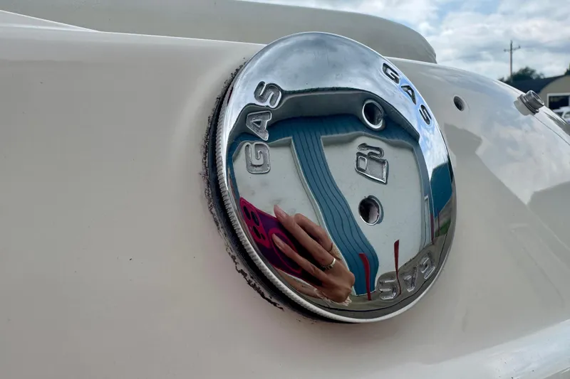 Slide: The Image of Close-up of a 2008 Glastron GT 225 gas cap with reflective chrome finish. - 17