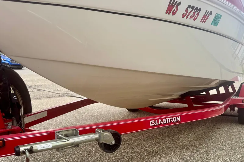 Slide: The Image of 2008 Glastron GT 225 boat on red trailer, close-up view of hull and trailer details. - 15