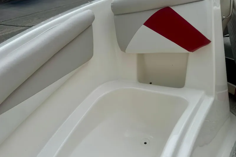 Slide: The Image of Interior detail of a 2008 Glastron GT 225 boat, featuring white and red upholstery. - 44