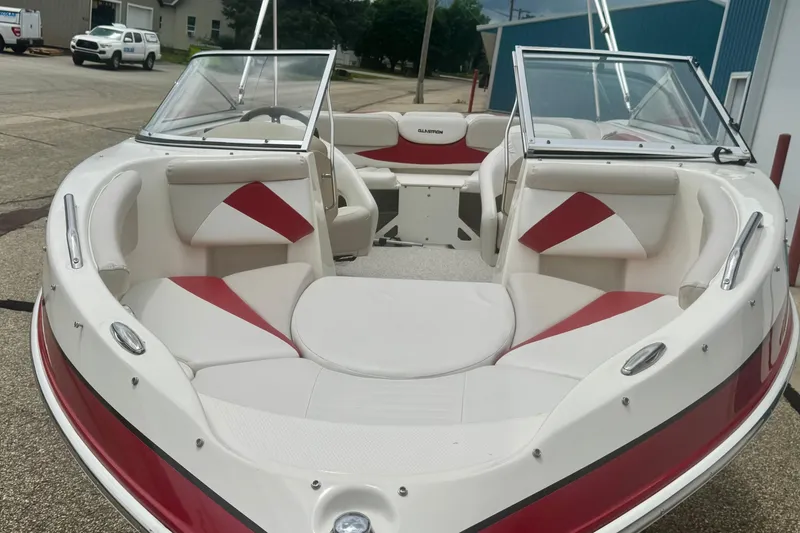 Slide: The Image of 2008 Glastron GT 225 boat with red and white interior, parked outdoors. - 66