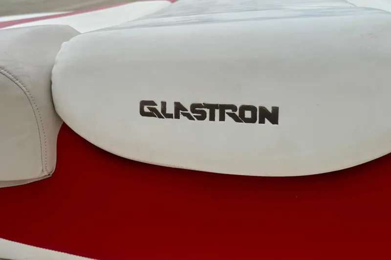 Slide: The Image of 2008 Glastron GT 225 boat seat with logo on red and white upholstery. - 47