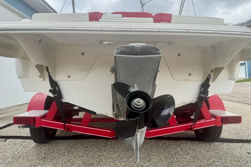 Slide: The Image of 2008 Glastron GT 225 boat on red trailer, rear view with propeller visible. - 9