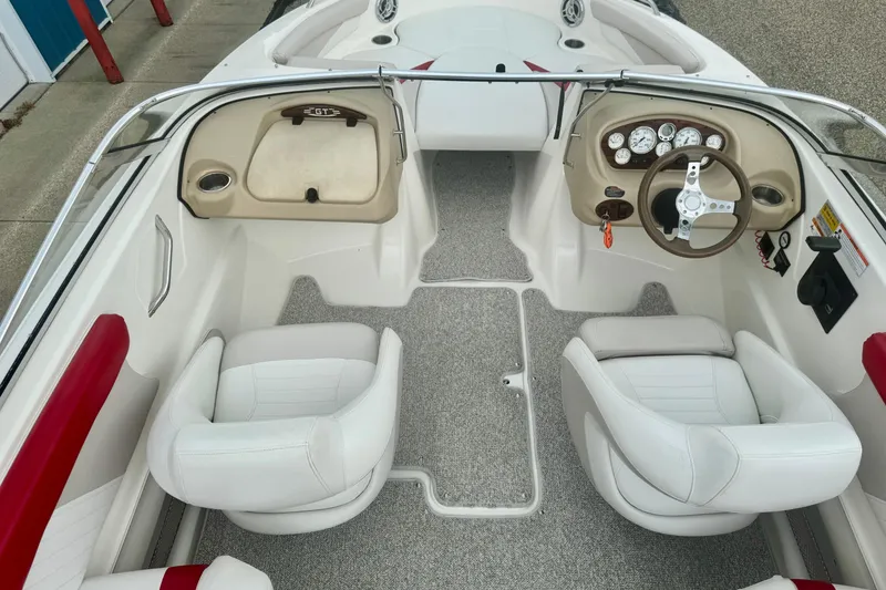 Slide: The Image of 2008 Glastron GT 225 boat interior with white seats and modern dashboard. - 23