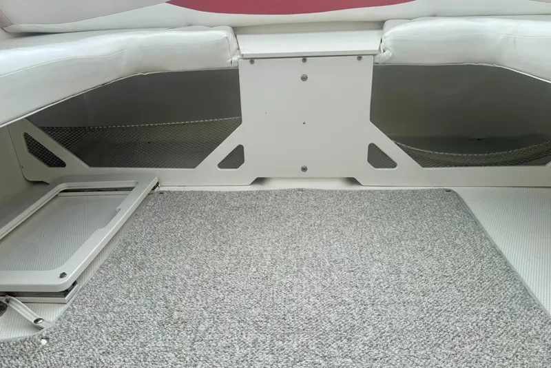 Slide: The Image of Interior view of a 2008 Glastron GT 225 boat with carpeted flooring. - 31