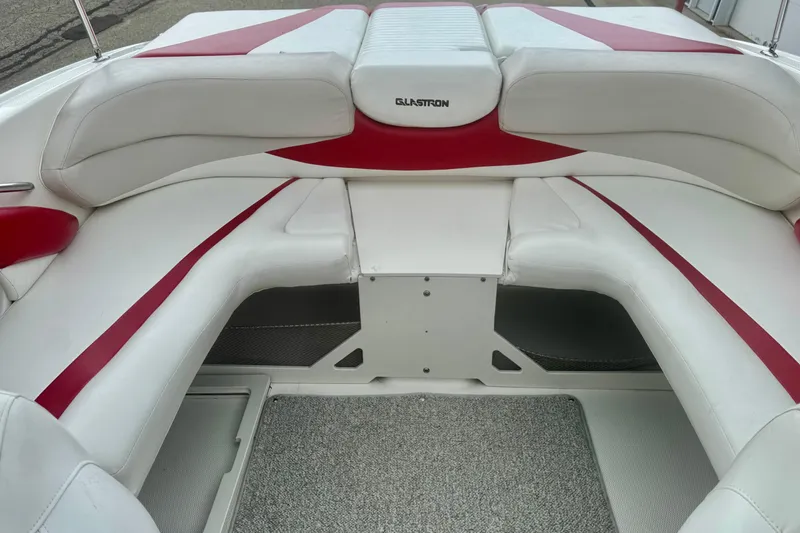 Slide: The Image of 2008 Glastron GT 225 boat interior with white and red seating, showcasing spacious design. - 22