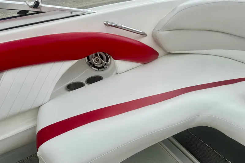 Slide: The Image of 2008 Glastron GT 225 boat interior with white and red seating, featuring cup holders and speaker. - 29