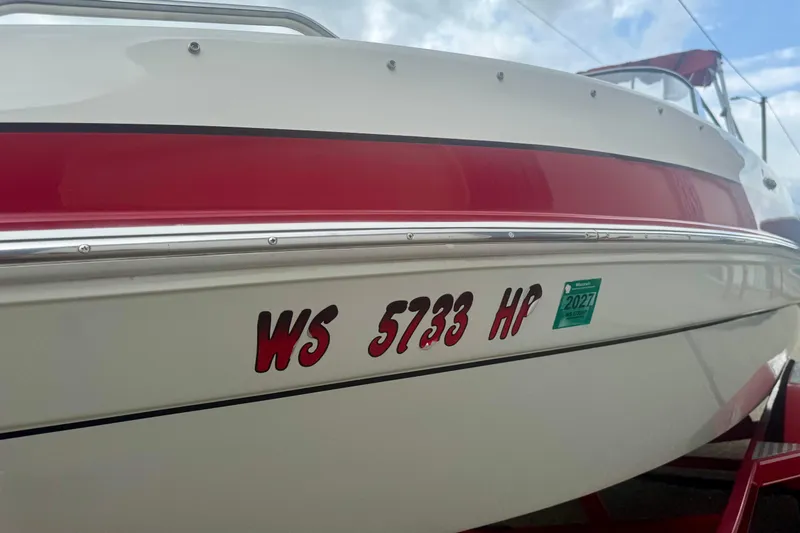Slide: The Image of 2008 Glastron GT 225 boat with red stripe and registration number WS 5733 HP. - 14