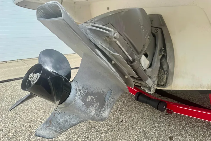 Slide: The Image of 2008 Glastron GT 225 boat propeller and outdrive on a red trailer. - 62