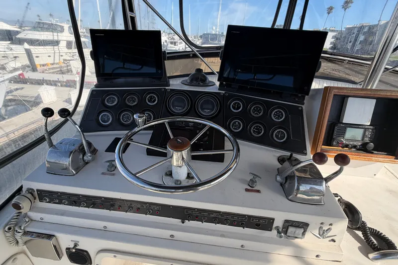 Slide: The Image of Cockpit of a 1978 Bertram 46 Convertible yacht with steering wheel and control panels. - 18