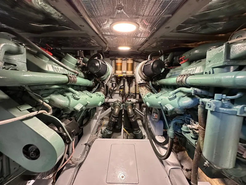 Slide: The Image of Engine room of a 1978 Bertram 46 Convertible yacht, showcasing dual engines and mechanical components. - 20