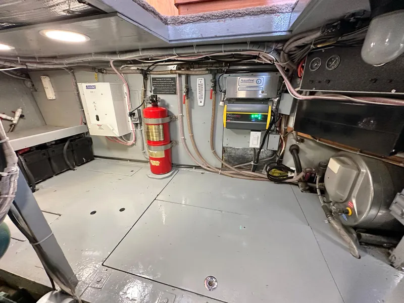 Slide: The Image of 1978 Bertram 46 Convertible engine room with fire extinguisher and electrical panels. - 28