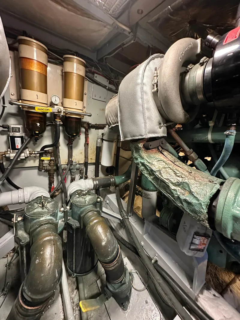 Slide: The Image of Engine room of a 1978 Bertram 46 Convertible boat, showcasing mechanical components. - 25