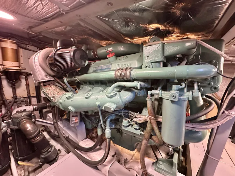 Slide: The Image of Engine room of a 1978 Bertram 46 Convertible boat, showcasing a diesel engine. - 22