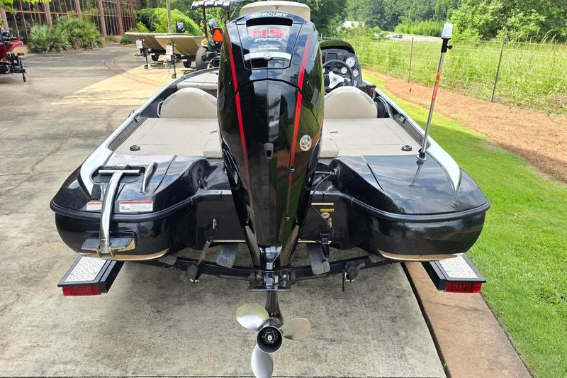 Slide: The Image of 2013 Nitro Z-6 boat with Mercury engine, parked on a driveway. - 4