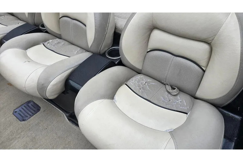 Slide: The Image of Worn beige seats in a 2013 Nitro Z-6 boat, showing visible wear and tear. - 14