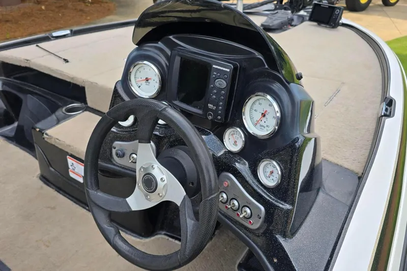 Slide: The Image of Steering console of a 2013 Nitro Z-6 boat with gauges and controls. - 8