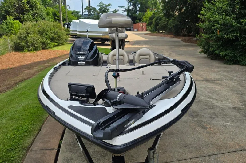 Slide: The Image of 2013 Nitro Z-6 boat with Minn Kota trolling motor on a driveway. - 7