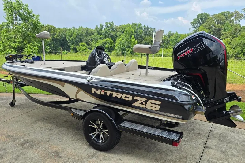 Slide: The Image of 2013 Nitro Z-6 boat with Mercury Pro XS engine, parked outdoors on a sunny day. - 3
