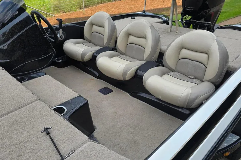 Slide: The Image of Interior of a 2013 Nitro Z-6 boat with three beige seats and carpeted flooring. - 9