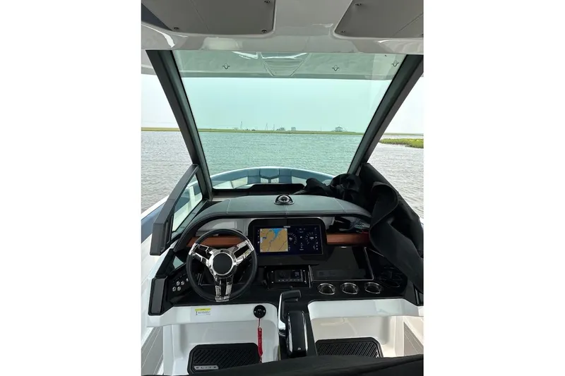 Slide: The Image of Cockpit view of 2026 Monterey Elite 25 OB boat with modern navigation system. - 8